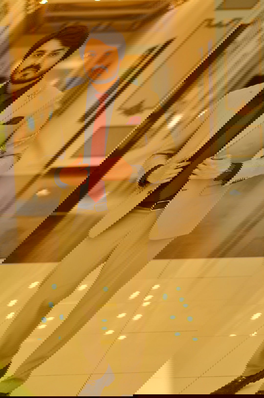 a man in a suit and tie standing in a hallway